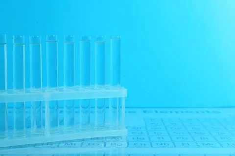 Test tubes on periodic table of elements, toned in light blue. Space for text 스톡 사진