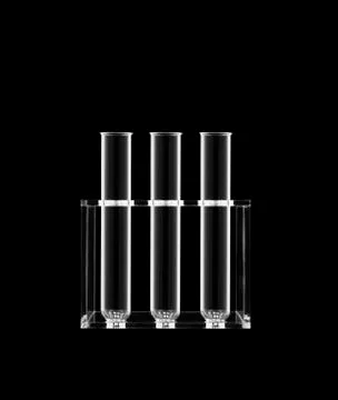 Test tubes in a rack on a black background. Stock Photos