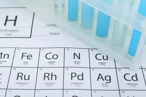 Test tubes in rack on periodic table of chemical elements, closeup Foto stock