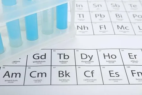 Test tubes in rack on periodic table of chemical elements, closeup Stock Photos