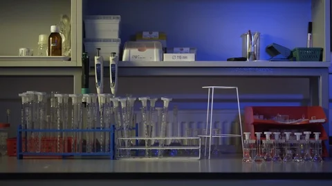 Test tubes on table in science lab Video stock 104076498