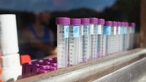 Test tubes in window of remote lab Stock Photos