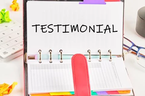 TESTIMONIAL word in an open notebook on a white background Stock Photos
