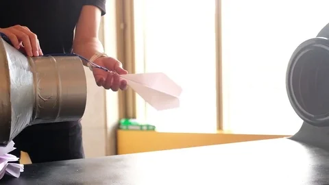 Testing the aerodynamics of paper airplane Stock Footage 80211976