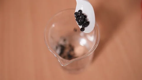 Testing the black eco plastic material granules samples at the laboratory Stock Footage 278478417