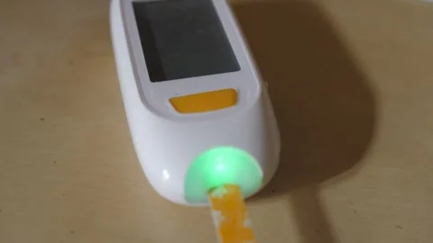 Testing blood sugar in glucose meter monitor for diabetes 4k  Stock Footage 281853716
