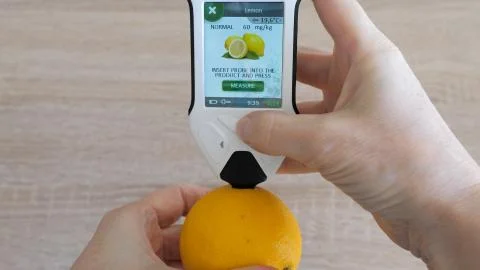 Testing content of nitrates in lemon. Nitrate Tester. Stock Photos