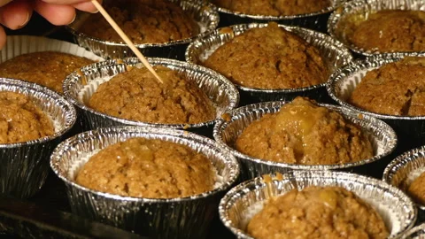 Testing Cupcakes with Care to Check for Baking Perfection Stock Footage 278383781