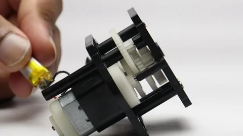 Testing dc motor and gears with battery power on small RC car steering mech.. Stock Footage 339017767