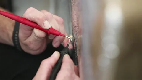 Testing electric wire voltage with professional digital multimeter Stock Footage 339298359