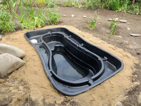 Testing of an installed preformed plastic pond insert filled with some wate.. Stock-Fotos