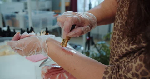 Testing lipstick shade on forearm with gloves Stock Footage 314616579