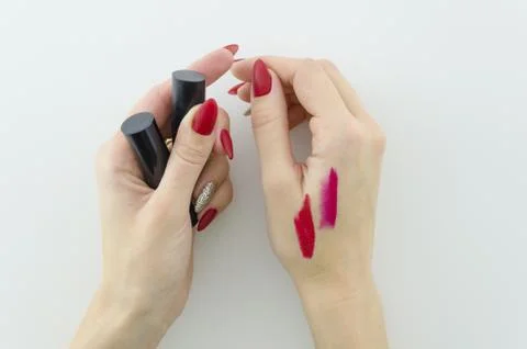 Testing makeup product a swatch of the red lipstick on woman hand with beautyful Stock Photos