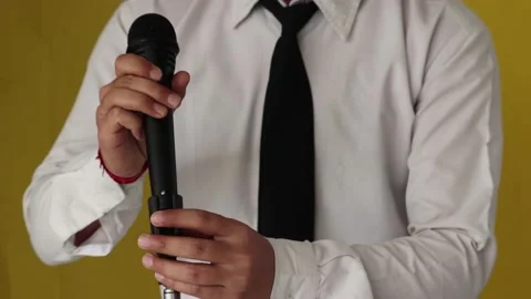 Testing a microphone by tapping it with the finger, close up Stock Footage 154031392