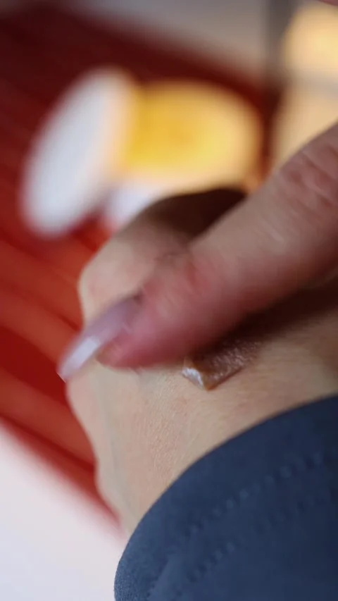 Testing moisturizing cream on the back of a woman's hand close-up Stockbeeldmateriaal 321860831