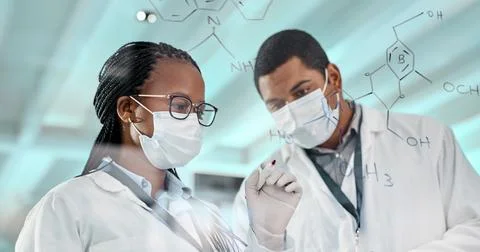 Testing a new formula. two scientists drawing molecular structures on a glass Stock Photos