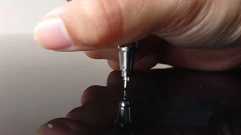 Testing a new pen on a shiny brown table Stock Footage 146248007