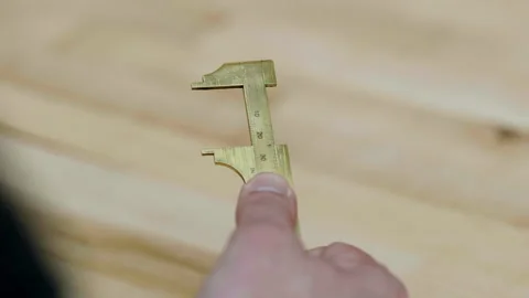 Testing out a caliper in a workshop during daylight hours Stock Footage 322785974