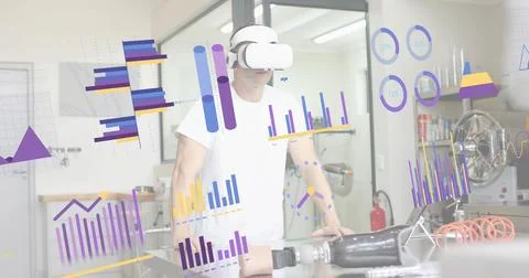 Testing prosthetic parts, tech wearing VR headset, white tee at bench in lab, Stock Photos