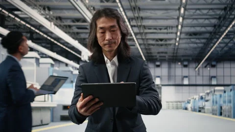 Testing silicon wafer batches, tablet and senior manager in microchip factory Stock Footage 333392471