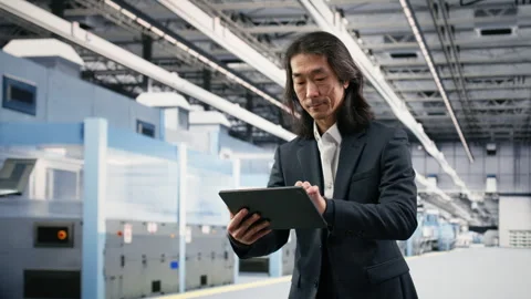 Testing silicon wafer batches, tablet and businessman in microchip factory Stock Footage 333394833