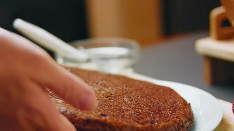 Testing the surface of a baked chocolate cake by hand, 4K Stock Footage 341120949