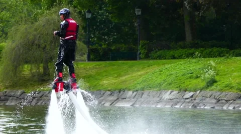 Testing the water jet pack flyboard for the first time inside river in the city Stock Footage 64002490