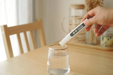Testing water quality with a meter at home Stock Photos