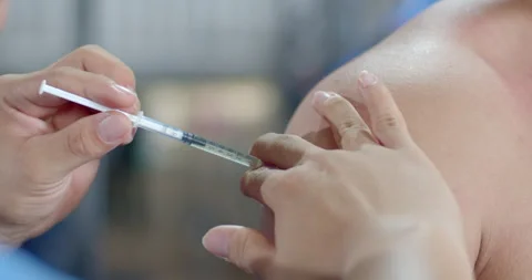 Testosterone injections in the shoulder.Increase Testosterone into the body. Stock Footage 282695158