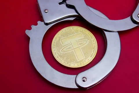 Tether coin and handcuffs Stock Photos