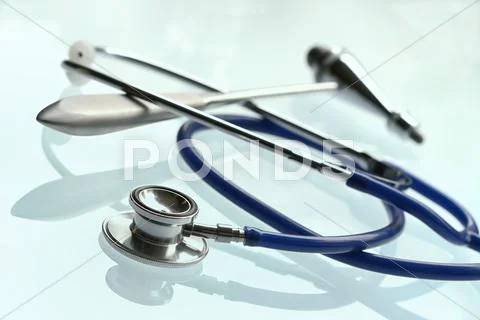 Tethoscope and of medical hammer on white background. Stock Photos