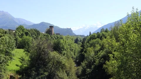 Tetnuldi peak, forest, river, valley and Svan tower. Mestia, Geogria Stock Footage 248618741