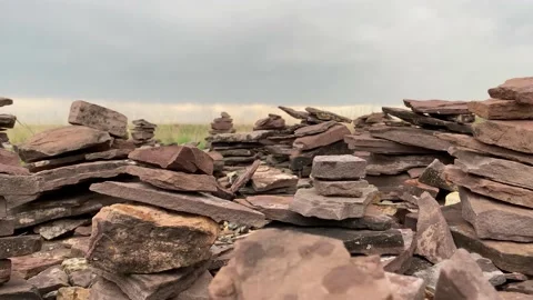 Tetrahedral earthen pyramids surrounded by a stone fence. Stock Footage 155972295