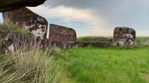 Tetrahedral earthen pyramids surrounded by a stone fence. Stock Footage 155972364