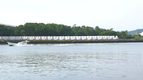 Tetrapod "breakwater blocks" and  boat Stock Footage 158371069
