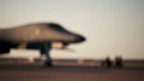 TEXAS - 12.25.2025 - A USAF flight crew prepares a B-1B Lancer at sunset and it Stock Footage 337719733