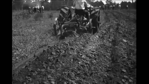 TEXAS - 1920 - A tractor plowing a field with 12” plow points on a 14” base, Stock Footage 312792386
