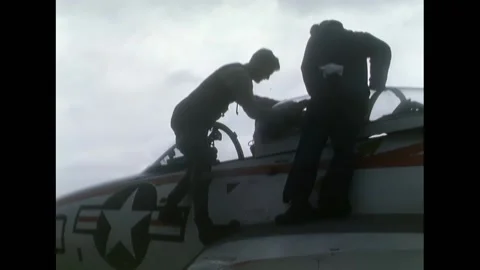 TEXAS - 1968 - A pilot climbing up the side of the Grumman F9F Panther, checking Stock Footage 312791470