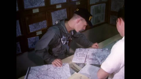 TEXAS - 1968 - The pilot reads the weather map inside the NAVCAD office. An Stock Footage 312792149