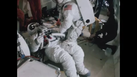 TEXAS - 1971 - An astronaut helps a fallen colleague get onto a lunar rover for Stock Footage 340665968