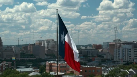 Texas Flag, aerial camera orbits right with Capital and Austin in the back, 4K,B 스톡 동영상 111067795