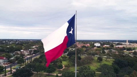 Texas Flag Blowing Orbiting Aerial Austin Stock Footage 84703498