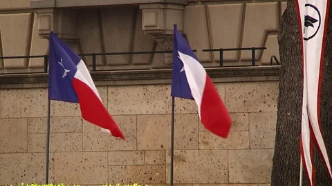Texas flags waving in Austin Texas Stock Footage 82852801