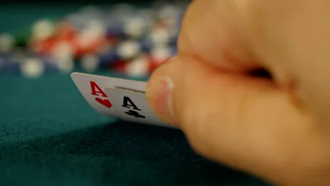 Texas Holdem player checking hole cards and betting Video stock 221416837