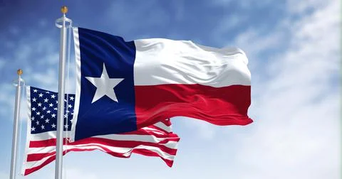 The Texas state flag waving along with the national flag of the United States Stock Photos