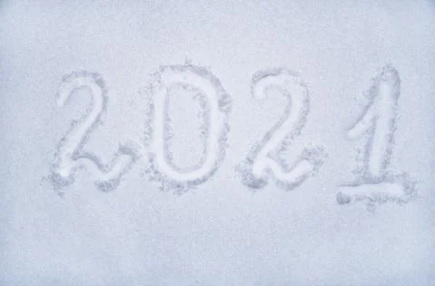 Text 2021 written on the snowy surface, new year, place to copy, flat lay Stock Photos