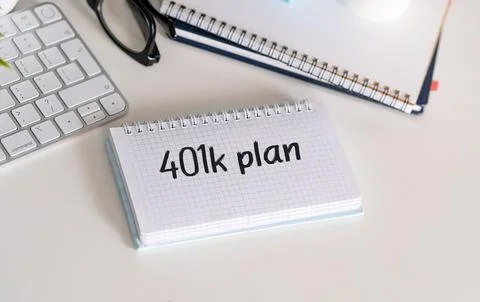 Text 401K Plan with tablet, keyboard, calculator, notepad and financial graph Stock Photos