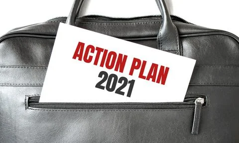 Text ACTION PLAN 2021 writing on white paper sheet in the black business bag. Stock Photos