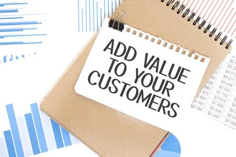 Text ADD VALUE TO YOUR CUSTOMERS on white paper sheet and brown paper notepad Stock Photos