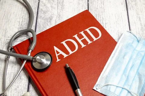 Text ADHD (attention deficit hyperactivity syndrome) on wooden doctor's table Stock Photos